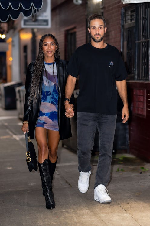 Tayshia Adams and Zac Clark walk hand in hand in New York City.