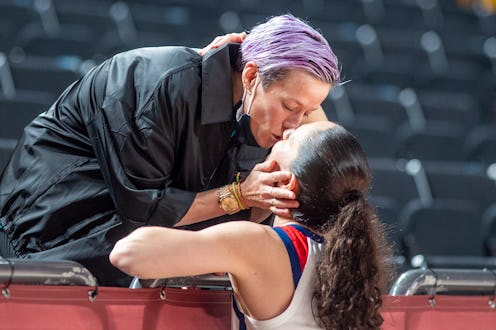 TOKYO, JAPAN August 8: Sue Bird #6 of the United States is congratulated by partner US soccer player...
