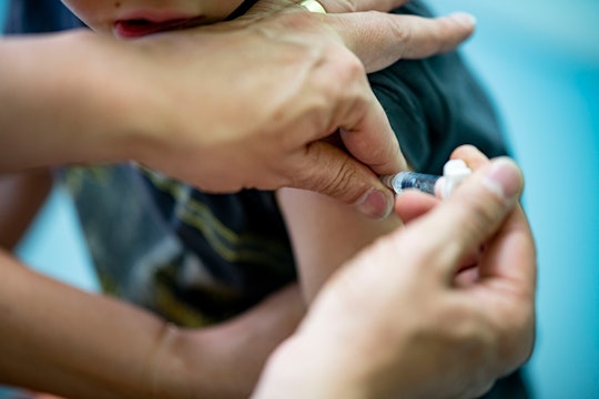 07 June 2021, Berlin: A pediatrician administers a booster of a dtp combination vaccine to a boy. Ph...
