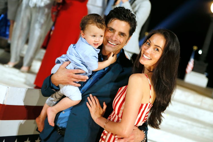 Stamos smiling for a photo with his wife Caitlin McHugh and son Billy.