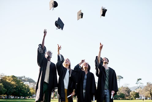 Shot of a group of students throwing their hats in the air on graduation day