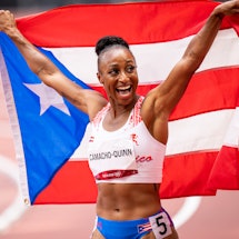 Jasmine Camacho-Quinn poses with the Puerto Rican flag after competing in the Women's 100m Hurdles F...