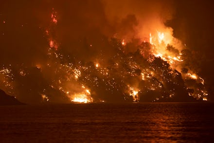 Wildfire approaches the seaside village of Limni, on the island of Evia, Greece, on August 6, 2021. ...