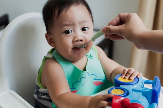 baby boy eating in high chair