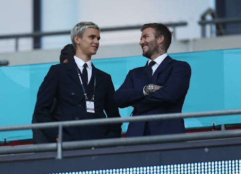 LONDON, ENGLAND - JUNE 18: Romeo Beckham and David Beckham, Former England International react as th...