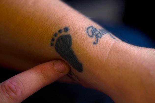Baby footprint of baby tattooed on woman's wrist. 