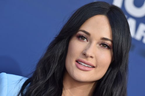 Kacey Musgraves' VMAs 2021 red carpet look included a bold, poufy hat that channeled Red Hat Society...