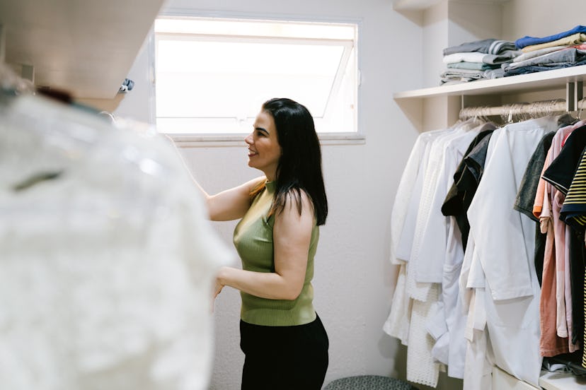 Woman choosing clothes in closet