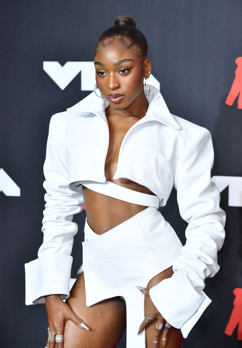 Normani's sexy, white 2021 VMAs outfit features a super short skirt and cropped jacket
