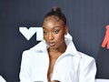 Normani's sexy, white 2021 VMAs outfit features a super short skirt and cropped jacket