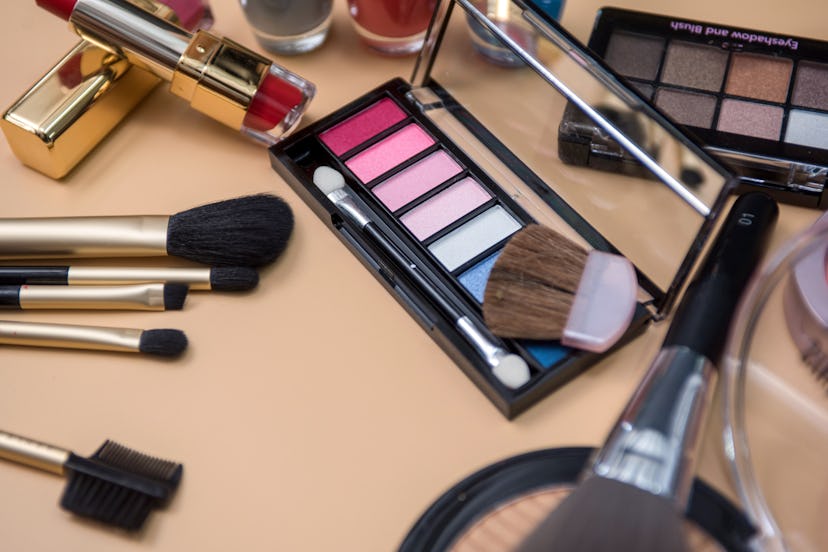 Eyeshadow makeup brushes near colourful eyeshadow pallets