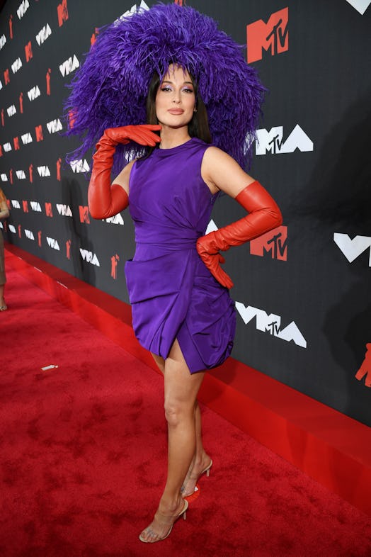 Kacey Musgraves' VMAs 2021 red carpet look included a bold, poufy hat that channeled Red Hat Society...