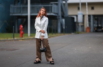 BERLIN, GERMANY - SEPTEMBER 07: Romina Palm wearing a white jacket, a black mini bag, brown trousers...