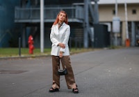 BERLIN, GERMANY - SEPTEMBER 07: Romina Palm wearing a white jacket, a black mini bag, brown trousers...