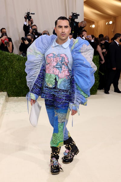 Dan Levy attends The 2021 Met Gala in a colorful Loewe suit.