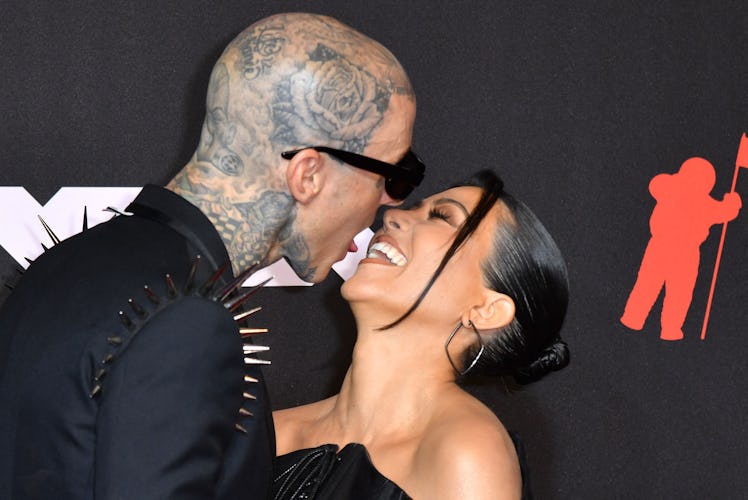 Travis Barker and Kourtney Kardashian kissing on the red carpet at the 2021 VMAs.