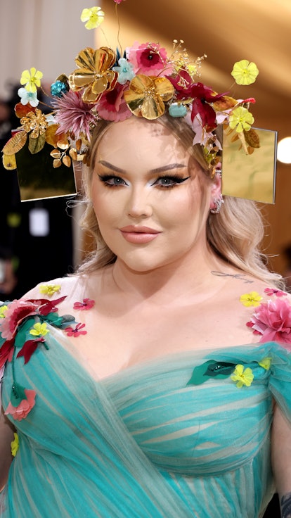 NikkieTutorials aka Nikkie de Jager wears a flower crown as part of her 2021 Met Gala ensemble.