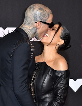 Travis Barker and Kourtney Kardashian kissing on the red carpet at the 2021 VMAs.