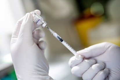A medical professional draws a dose of the Biontech/Pfizer Covid-19 vaccine onto a syringe in prepar...