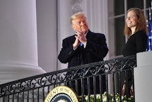 US President Donald Trump applauds Judge Amy Coney Barrett after she was sworn in as a US Supreme Co...