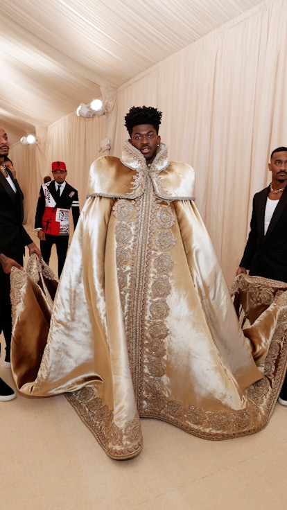 Lil Nas X's first Versace look on the 2021 Met Gala carpet was a large gold robe.