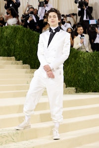 Co-chair Timothée Chalamet attends The 2021 Met Gala  in a white satin Haider Ackermann.