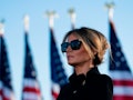 Outgoing First Lady Melania Trump listens as her husband Outgoing US President Donald Trump addresse...