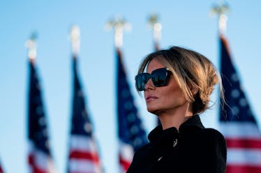 Outgoing First Lady Melania Trump listens as her husband Outgoing US President Donald Trump addresse...