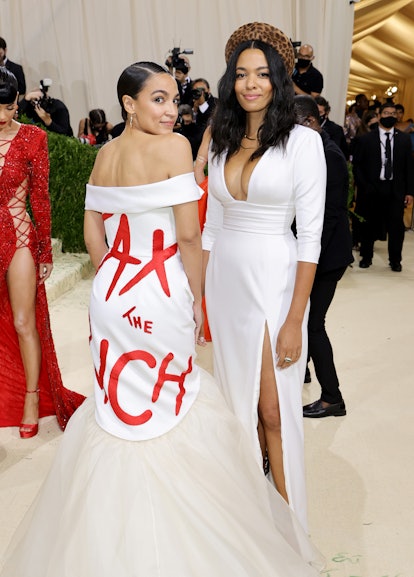 AOC's Met Gala 2021 look sent a bold message: Let's eat the rich. See her dress by designer Aurora J...