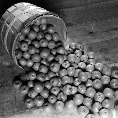 1930s BUSHEL BASKET OF APPLE SPILLING OUT ONTO WOODEN FLOOR  (Photo by H. Armstrong Roberts/ClassicS...