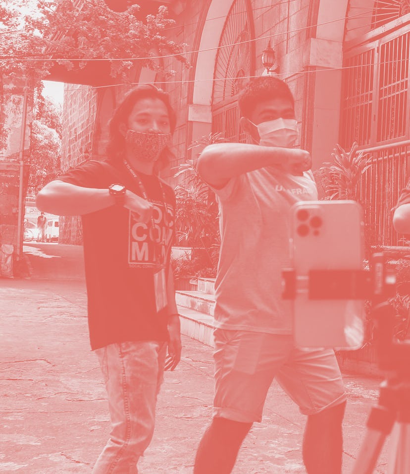 This photo taken on April 8, 2021 shows Philippine priest Father Paul Woo (2nd R) learning a dance f...