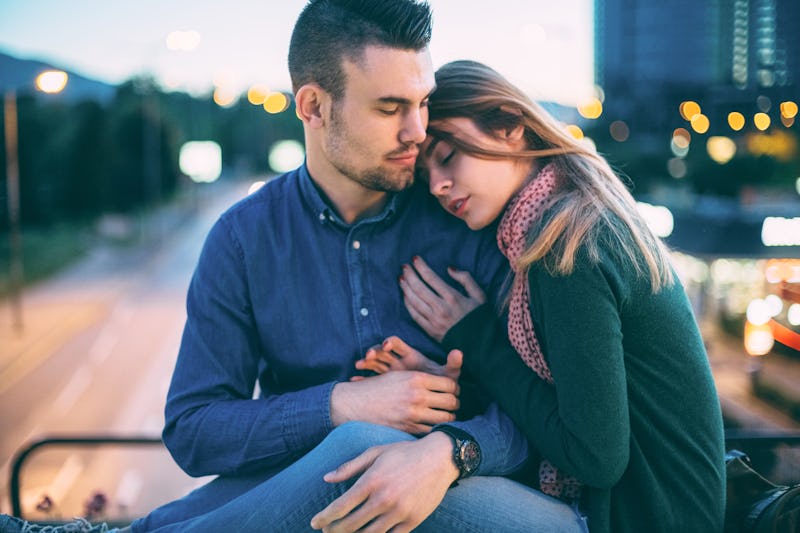 Young couple in love hugging outside