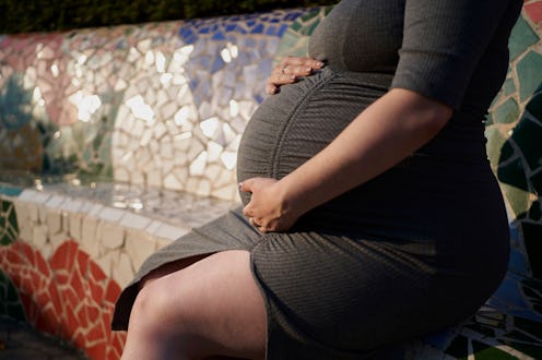 right view mother no face pregnancy casual clothing hands on stomach