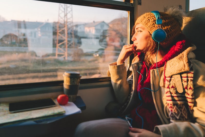 Thoughtful woman in the train looking through the window