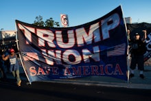 Former US President Donald Trump supporters are seen as a motorcade with US President Joe Biden arri...