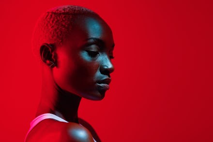 Red filtered shot of a beautiful young woman posing in the studio
