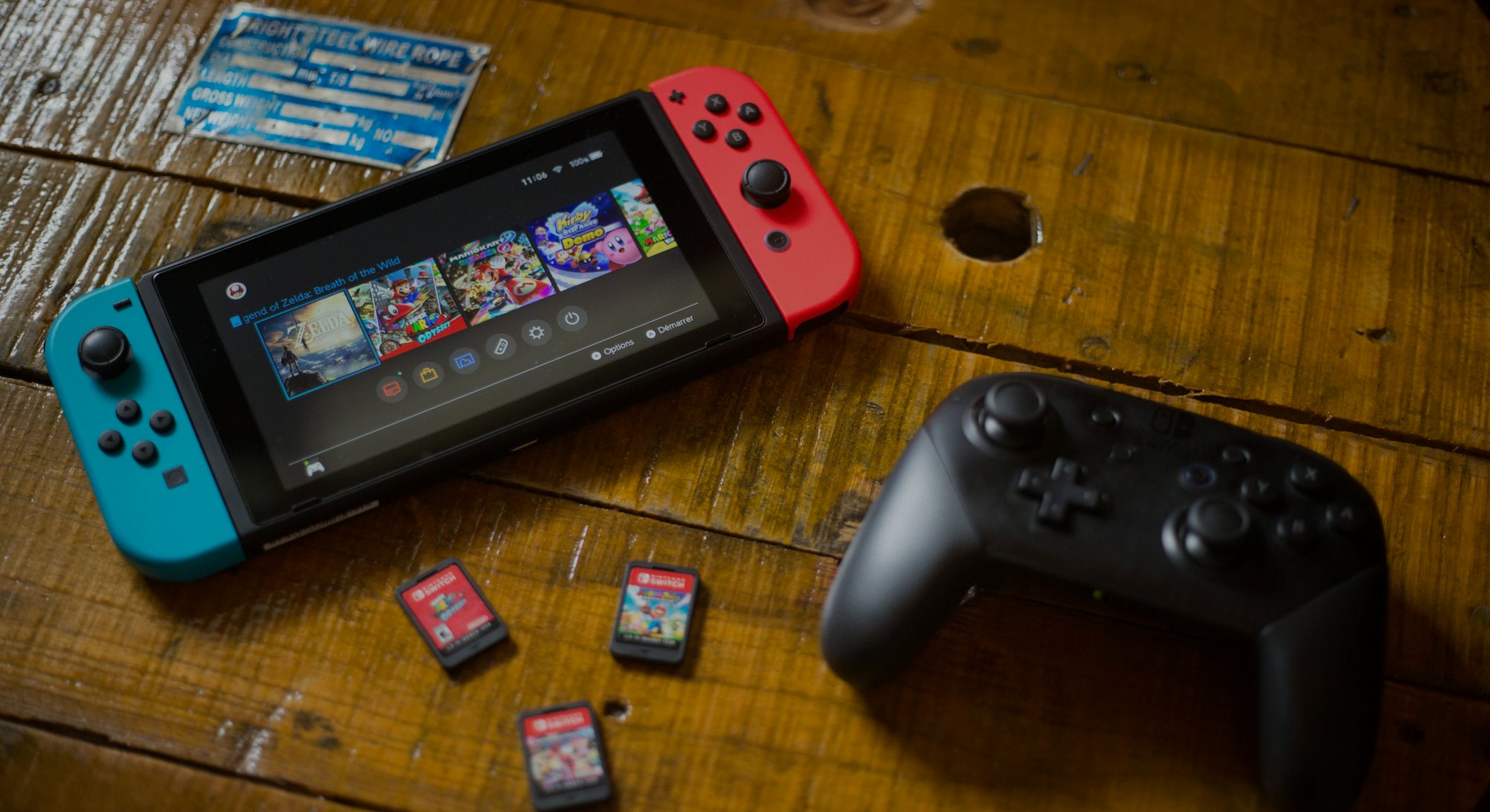 In this photo illustration, a turned on Nintendo Switch with 2 Joy-Con attached on it, a Pro Control...