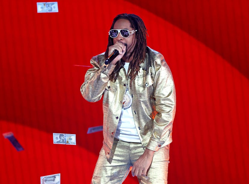 Lil Jon performing on stage in a gold outfit