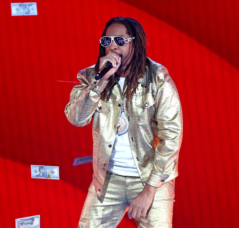 Lil Jon performing on stage in a gold outfit