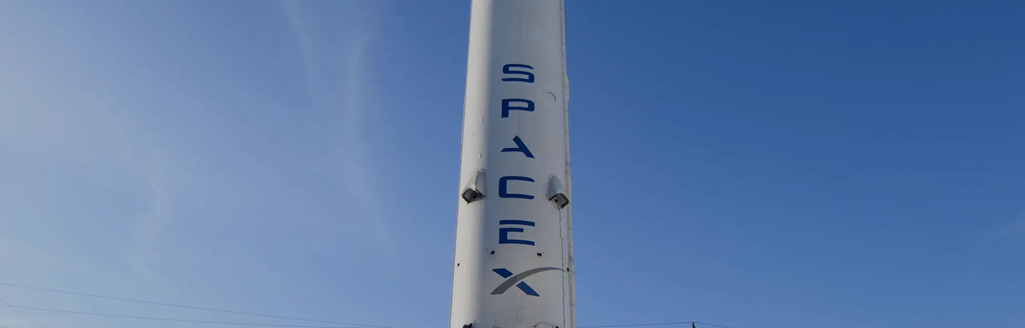 The recovered first stage of a Falcon 9 rocket stands at Space Exploration Technologies Corp. (Space...