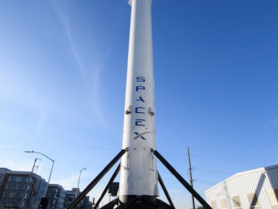 The recovered first stage of a Falcon 9 rocket stands at Space Exploration Technologies Corp. (Space...