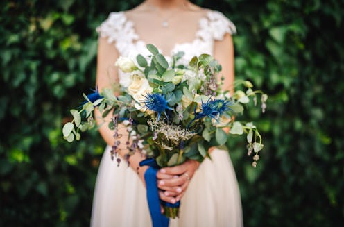 Unrecognizable woman holding beautiful flower bouquet