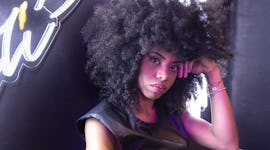 young woman looking into camera with a serious expression, reflecting on the emotional meaning of th...