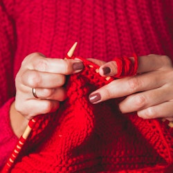 A woman in a red sweater knits a red sweater. Experts and women who've done it share tips for findin...