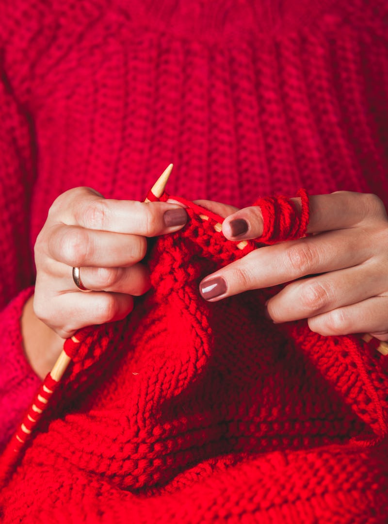 A woman in a red sweater knits a red sweater. Experts and women who've done it share tips for findin...