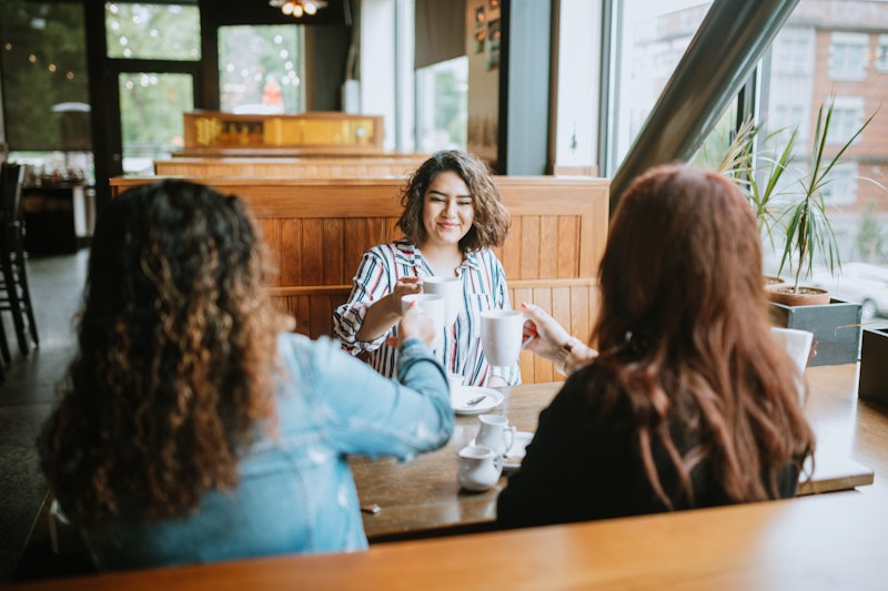 Three new friends have coffee at a diner. Experts share their tips for how to make friends in a new ...