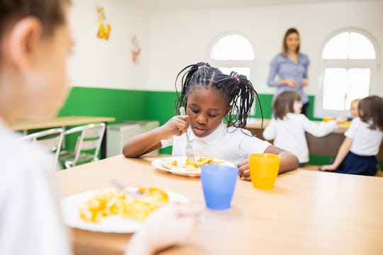 Back to school. Primary school children having school lunch at school cafeteria