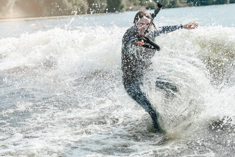 Young Adult Woman Wearing Black Wetsuit Training Wake Surfing Behind The Boat, Real People, Natural ...
