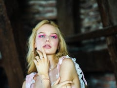 A model wearing a hot pink eyeshadow with a shimmering, halo center.