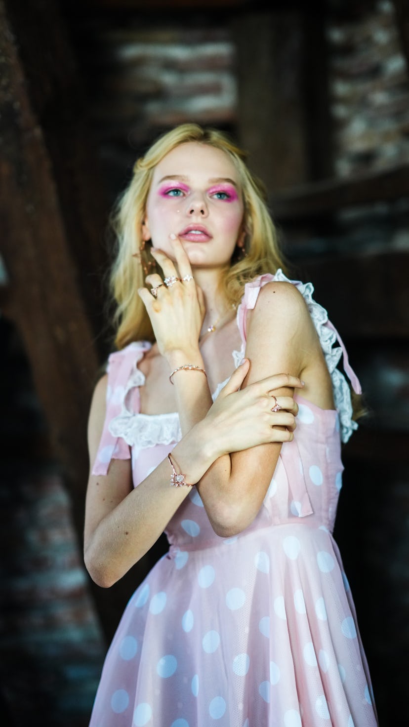 A model wearing a hot pink eyeshadow with a shimmering, halo center.